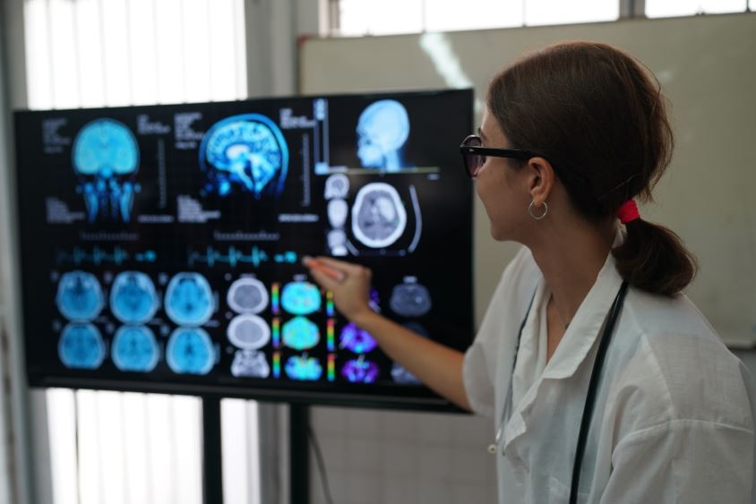 doctors looking at X-ray on medical conference, discussing issues Image description